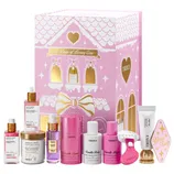 A pink-themed skincare set labeled \“10 Days of Luxury Care\“ includes items like body butters, serums, shaving cream, and a razor from the brand Truly. The packaging features a house design with gold accents.