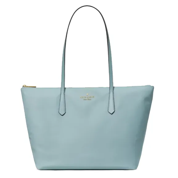 Light blue tote bag with long handles and a gold zipper, featuring a small brand logo in the center.