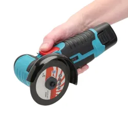 A person is holding a blue and black cordless angle grinder with a grinding disc attached.