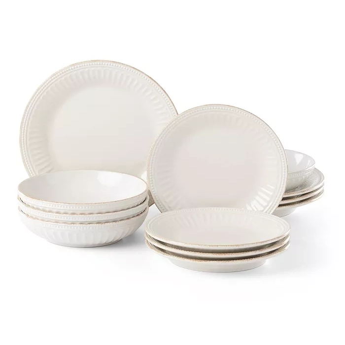 A 12-piece Lenox French Perle dinnerware set featuring scalloped edges and delicate beadwork on creamy white stoneware, including plates and bowls.
