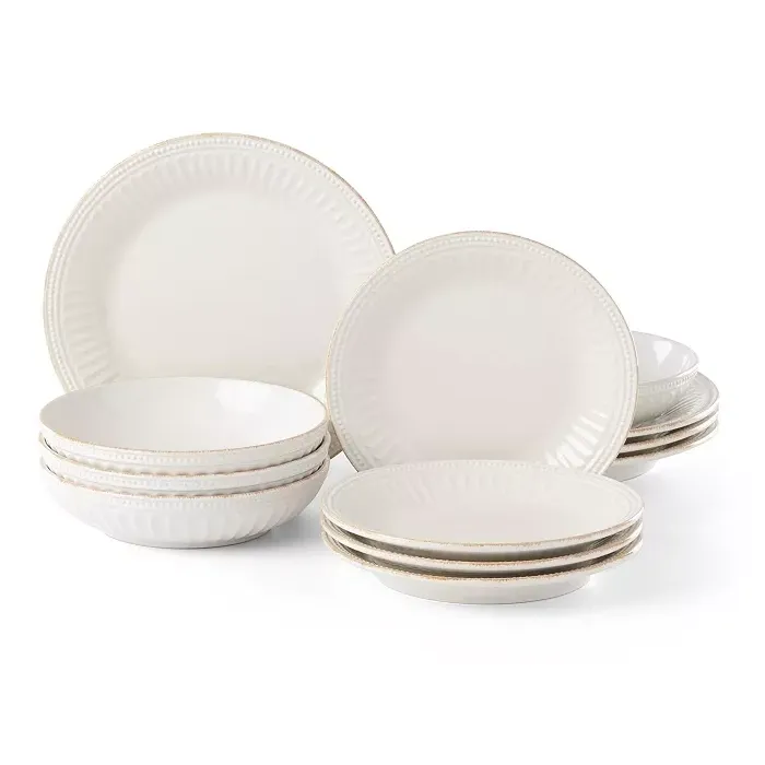 A 12-piece Lenox French Perle dinnerware set featuring scalloped edges and delicate beadwork on creamy white stoneware, including plates and bowls.