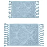 Two light blue, rectangular bath mats with tassel edges and a textured geometric pattern.