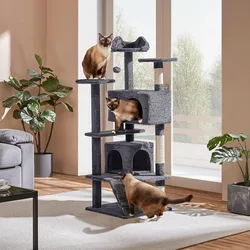 A multi-level gray cat tree with three Siamese cats perched on it, set in a sunny room with a large window and plants nearby.
