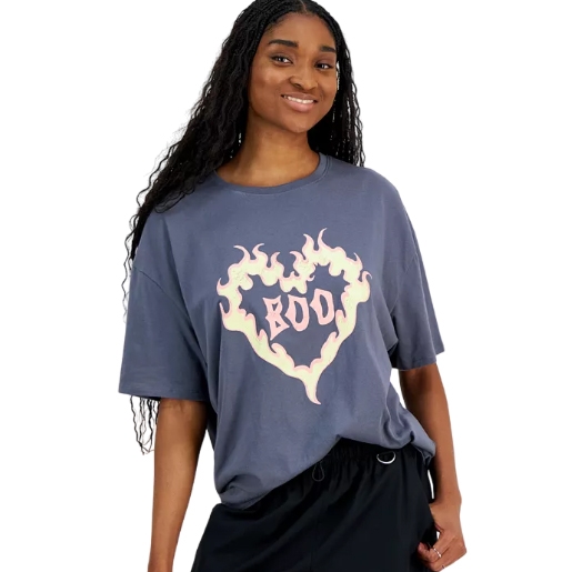 A woman is wearing a loose-fitting, navy blue T-shirt with a graphic of a heart surrounded by flames and the word \“BOO\“ in the center.