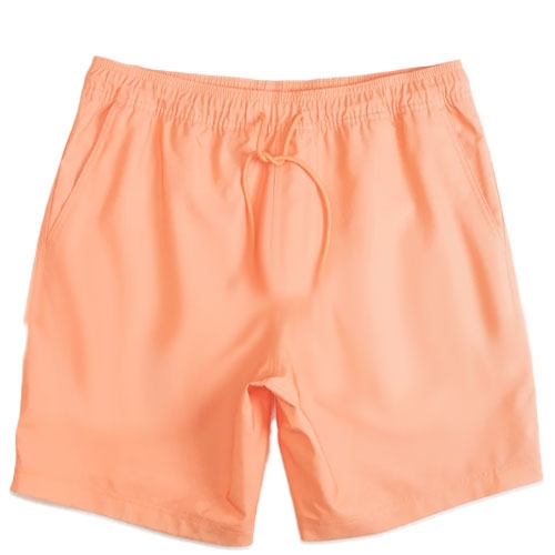 Light peach swim shorts with an elastic waistband, drawstring, and side pockets.