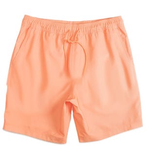 Light peach swim shorts with an elastic waistband, drawstring, and side pockets.