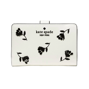 A white Kate Spade New York wallet features black floral embroidery and the brand logo on the front.