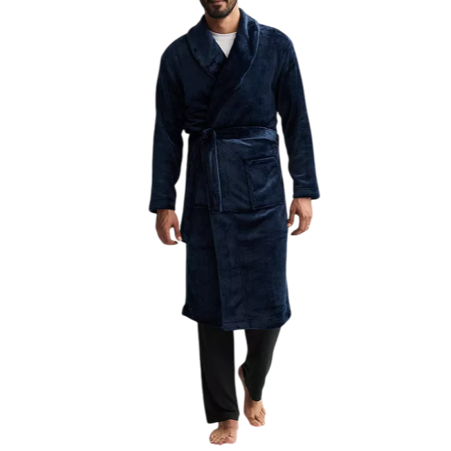 A man is wearing a dark blue robe with a shawl collar, tied at the waist, and black pants.