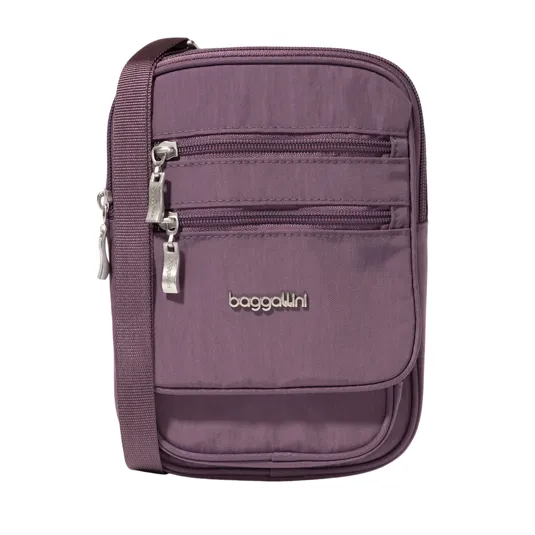 A purple Baggallini crossbody bag with multiple zippered compartments and a strap.
