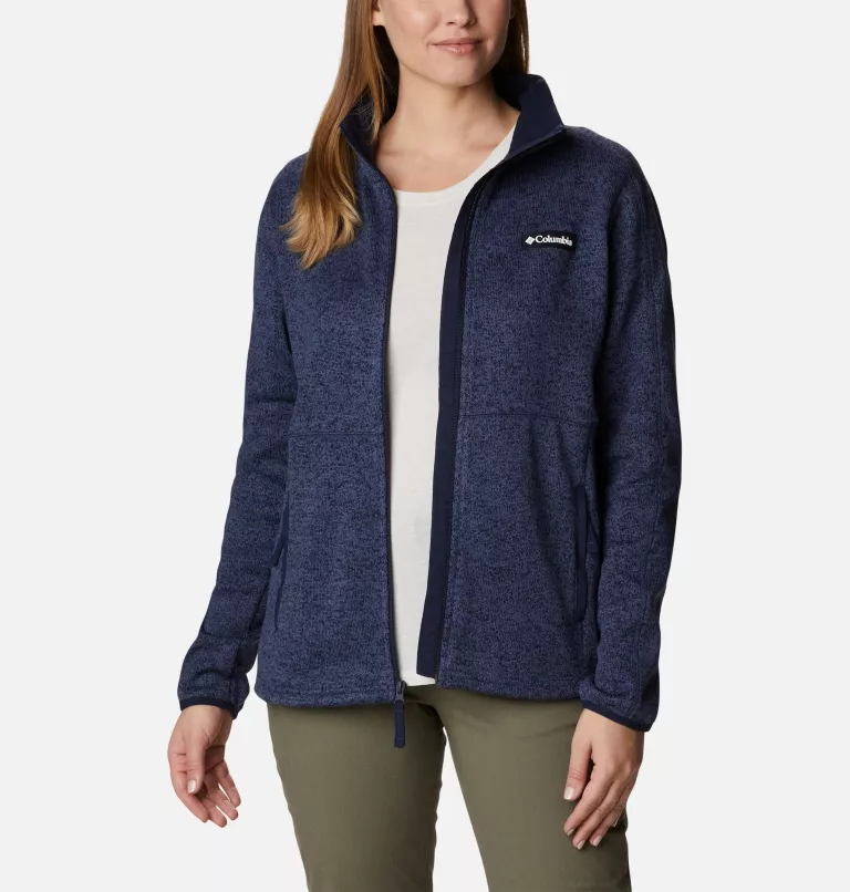 A woman wearing a blue Columbia fleece jacket with a zip-up front and side pockets.