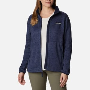 A woman wearing a blue Columbia fleece jacket with a zip-up front and side pockets.