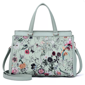 A light green handbag with floral patterns, featuring two short handles and a detachable shoulder strap.
