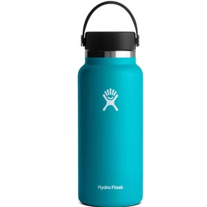 A teal Hydro Flask water bottle with a black cap and carrying handle, featuring a white logo on the side.