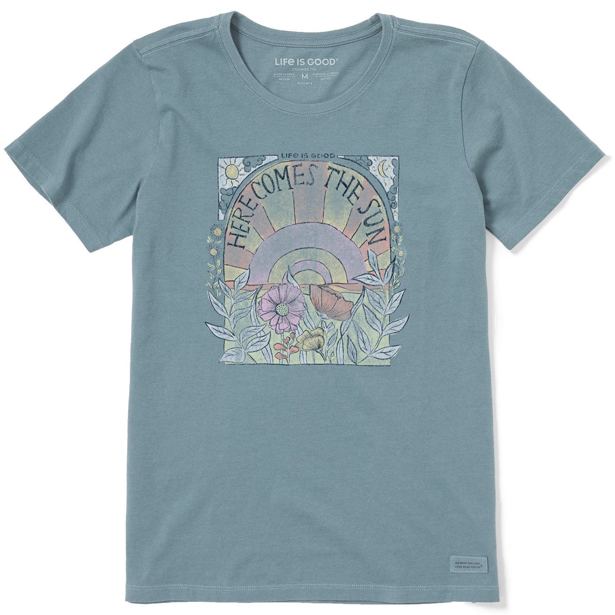 Blue T-shirt by \“Life is Good\“ featuring a graphic with a rising sun, flowers, and the text \“Here Comes the Sun\“.
