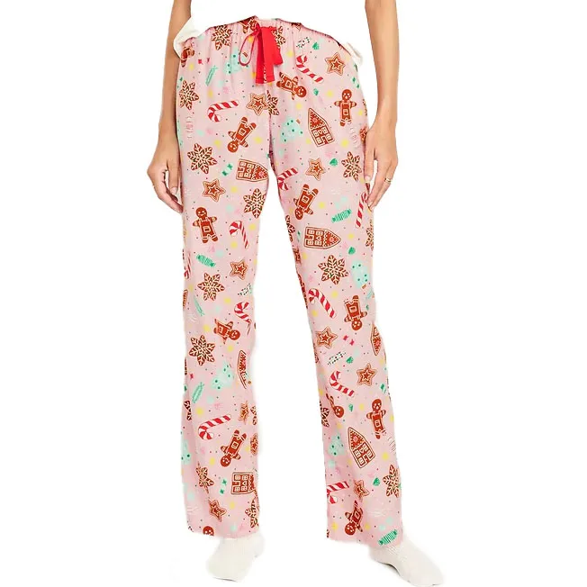 These are flannel holiday pajama pants with a festive print featuring gingerbread houses, snowflakes, and candy canes, and include a drawstring at the waist.