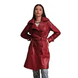 A woman is wearing a red leather trench coat with a tied belt and dark buttons, paired with light jeans.