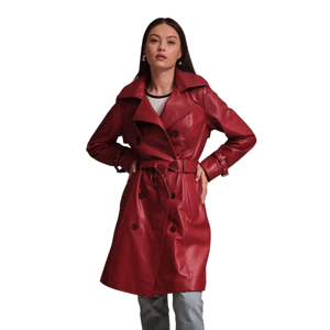A woman is wearing a red leather trench coat with a tied belt and dark buttons, paired with light jeans.