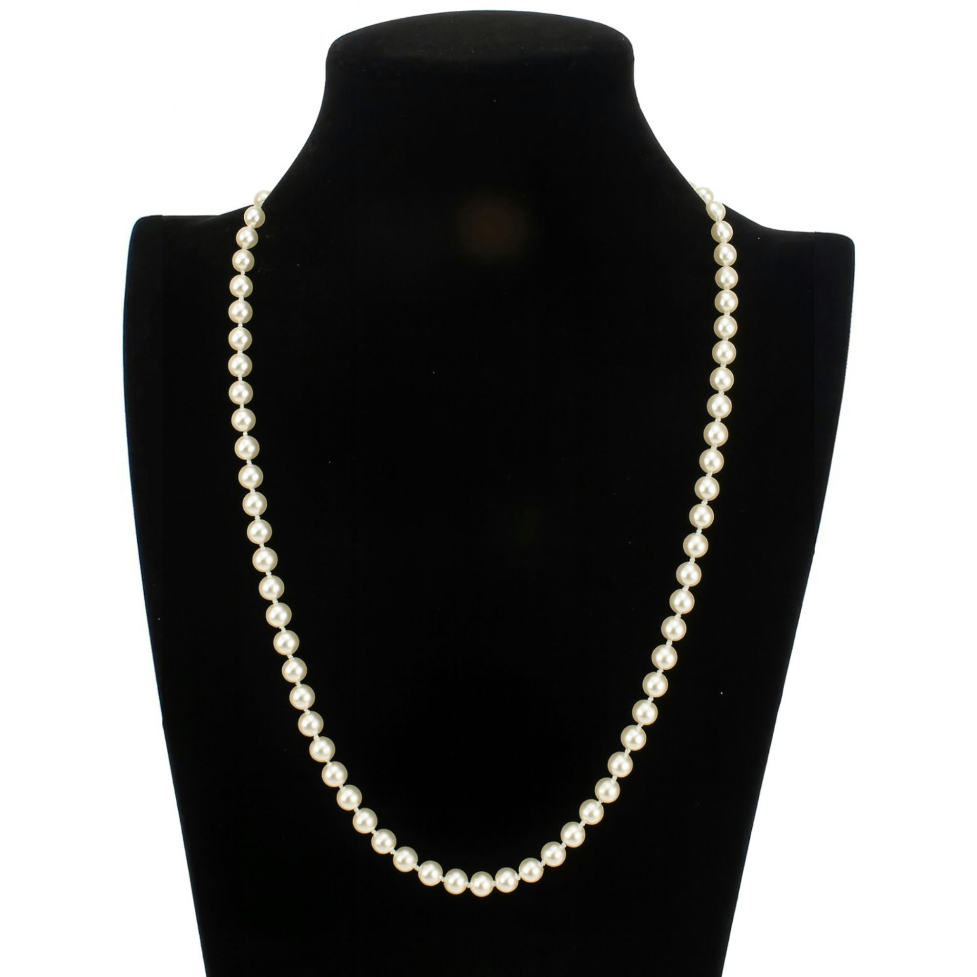 A single strand of white pearls is displayed elegantly on a black bust stand, showcasing a classic and timeless jewelry piece.
