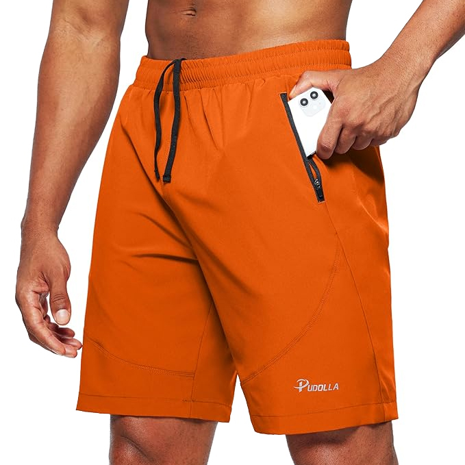 Men's orange running shorts with a black drawstring and zippered side pocket, designed by Pudolla.