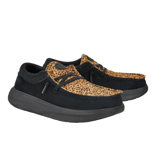 Casual shoes with a black base and leopard print accents, featuring a lace-up design and thick soles for comfort and style.