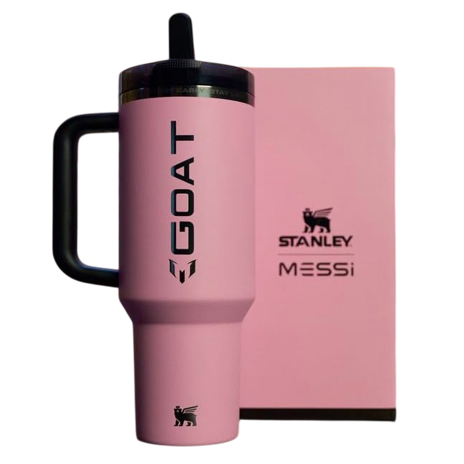 A pink Stanley tumbler with \“GOAT\“ and \“Messi\“ branding is displayed alongside a matching pink box.