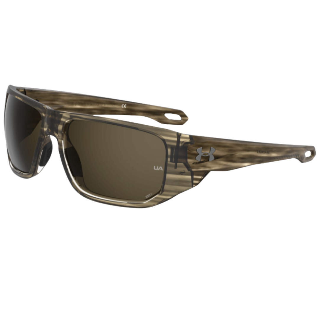 UA Attack 2 Sunglasses feature a rectangular design with a camouflage-patterned frame and dark lenses. They have the Under Armour logo on the temples and are designed for durability and outdoor use.