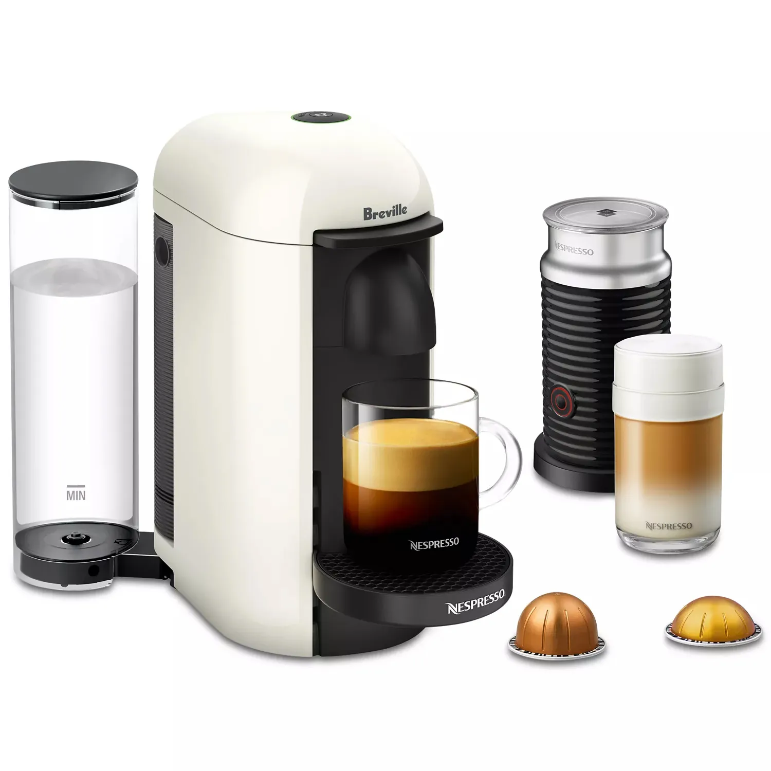 Breville Nespresso machine with a milk frother, glass coffee cup, and two coffee capsules. Features a removable water tank and separate frother for making various coffee styles.