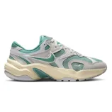 Nike sneakers with a retro design feature teal and beige colors, showcasing a wavy midsole and mesh accents for breathability.