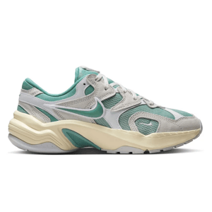 Nike sneakers with a retro design feature teal and beige colors, showcasing a wavy midsole and mesh accents for breathability.
