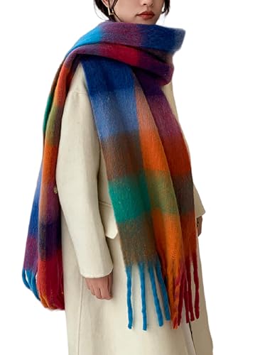 A person wears a thick, multicolored plaid scarf with a long fringe, paired with a light cream coat.