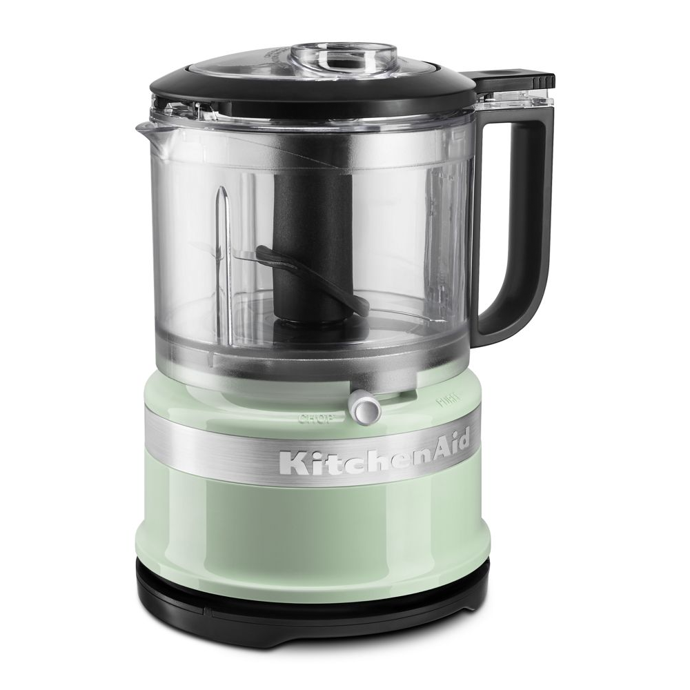 A KitchenAid mini food processor in a light green color with a transparent bowl and black handle, featuring a chop and puree setting.