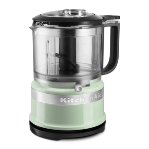 A KitchenAid mini food processor in a light green color with a transparent bowl and black handle, featuring a chop and puree setting.