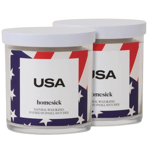 Two \“USA\“ Homesick candles with a patriotic red, white, and blue star design, featuring a natural wax blend.
