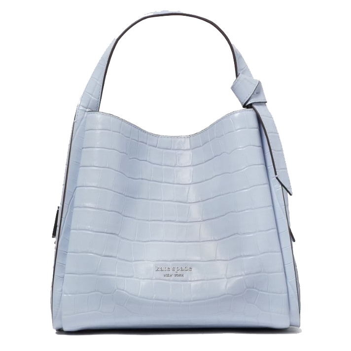 Light blue tote bag with a crocodile-embossed texture and the \“kate spade new york\“ logo. Features a single top handle with an adjustable strap detail.