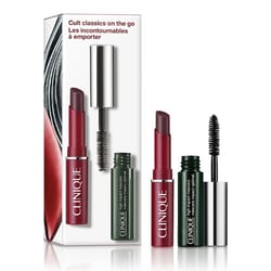 Clinique Cult Classics Makeup Duo includes a deep red lipstick and a mini black mascara, packaged in a box that highlights \“Cult classics on the go\“ in English and French.