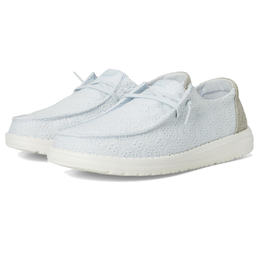 Light blue Hey Dude Wendy Shoes with a lace design, featuring a textured surface and white soles for a casual look.