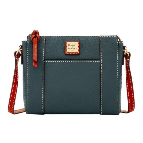 A blue leather crossbody bag with brown accents, featuring a front pocket and the Dooney & Bourke logo on a small square plaque.