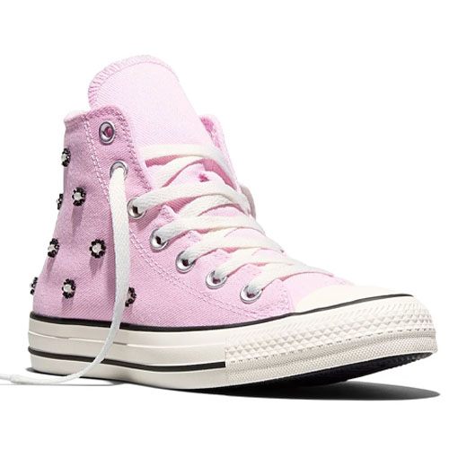 High-top sneaker in light pink with black flower embellishments, white laces, and a classic rubber sole with black accents.