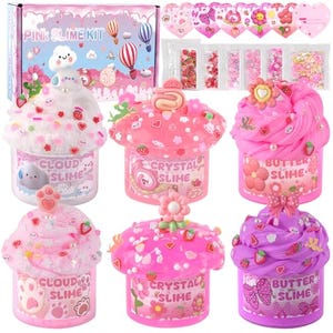 Pink slime kit featuring multiple containers of cloud, crystal, and butter slime, each adorned with colorful decorations like charms and sprinkles. The kit also includes additional decorative items, as shown next to the box.