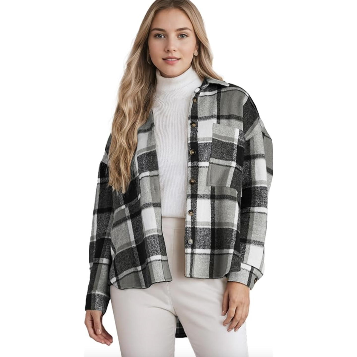 A woman wearing a black and white plaid button-up jacket over a white turtleneck sweater, paired with light-colored pants.