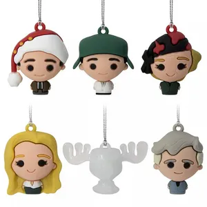 Holiday-themed keychains featuring cartoon-style characters with festive touches, including a Santa hat, and one shaped like a moose cup.