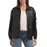 A black faux leather jacket with a zip front, featuring multiple pockets, elastic cuffs, and a collar, worn over a white V-neck top and blue jeans.