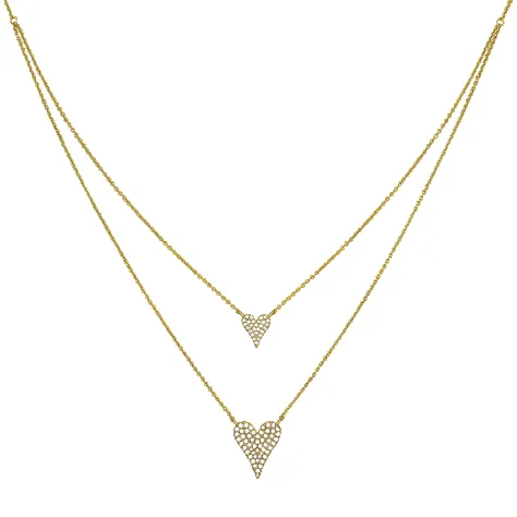 A gold-tone necklace featuring two heart-shaped pendants adorned with small, sparkling stones on a double-layer chain design.