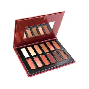 An eyeshadow palette with 12 warm-toned shades, including matte and shimmer finishes, in a red case with a mirror.