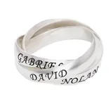A trio of intertwined silver rings with engraved names: Gabriel, David, and Nolan, in bold black lettering.