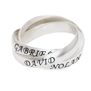 A trio of intertwined silver rings with engraved names: Gabriel, David, and Nolan, in bold black lettering.