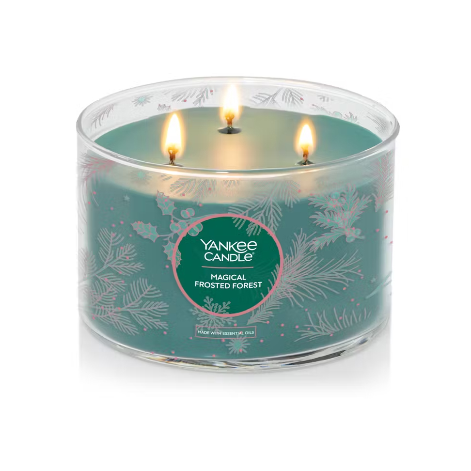 This is a large, 18-ounce Yankee Candle with three wicks, called Magical Frosted Forest, featuring a festive design of snowflakes and pine needles.
