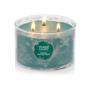This is a large, 18-ounce Yankee Candle with three wicks, called Magical Frosted Forest, featuring a festive design of snowflakes and pine needles.