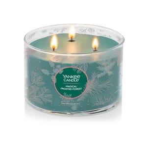 This is a large, 18-ounce Yankee Candle with three wicks, called Magical Frosted Forest, featuring a festive design of snowflakes and pine needles.