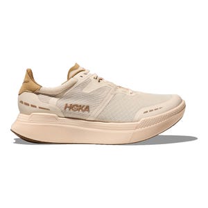 HOKA sneaker in a beige colorway with a chunky sole, breathable mesh upper, and brown accents.